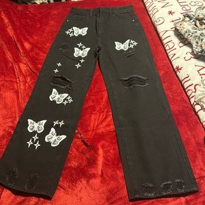 Pair of black pants with white butterflies down the front of them. NEVER WORN!